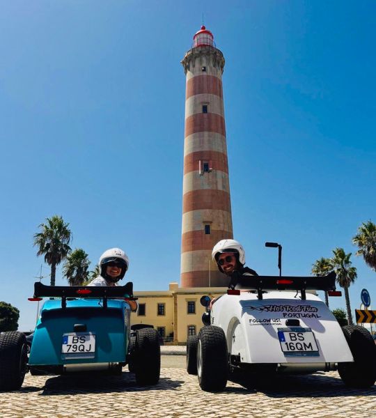 Guests enjoying a Hot Rod Fun Portugal tour in front of the famous Barra Lighthouse near Aveiro, Portugal.